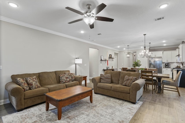 living room featuring crown molding, ceiling fan with notable chandelier, and light hardwood / wood-style floors