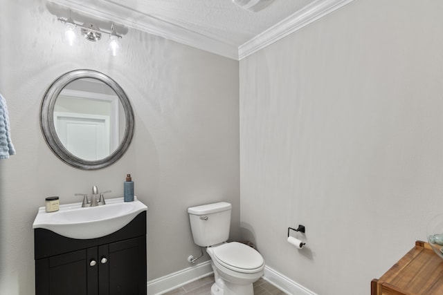 bathroom with crown molding, vanity, and toilet