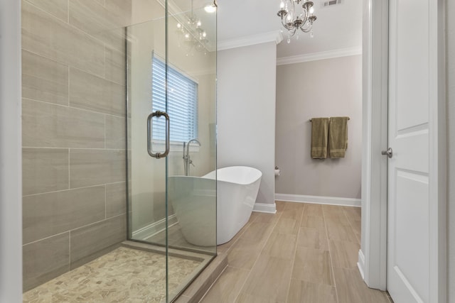 bathroom with crown molding, separate shower and tub, and a chandelier