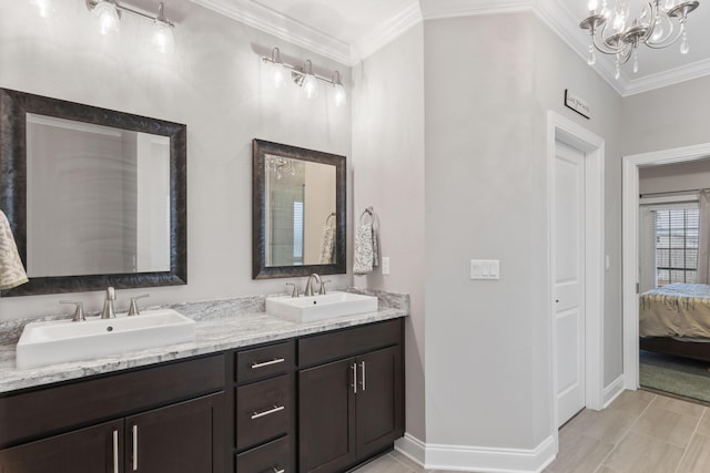 bathroom with a notable chandelier, crown molding, and vanity