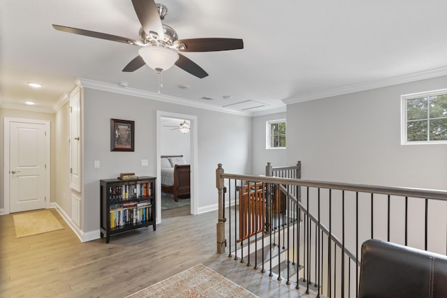 hallway with crown molding and light wood-type flooring