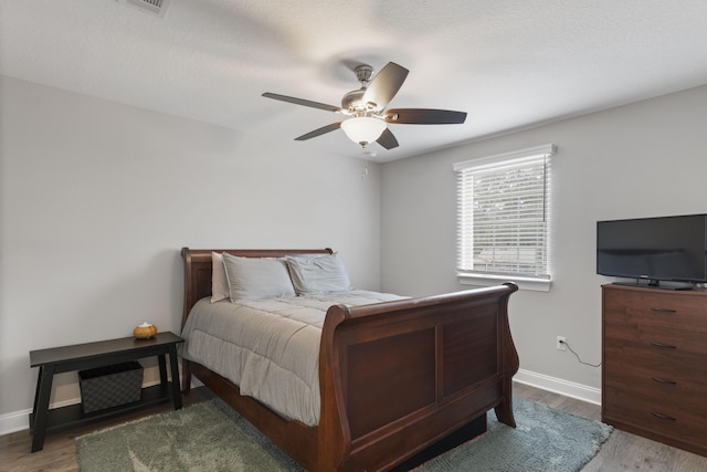 bedroom with wood-type flooring and ceiling fan