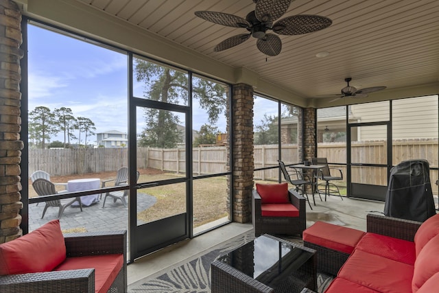 sunroom / solarium with a healthy amount of sunlight and ceiling fan