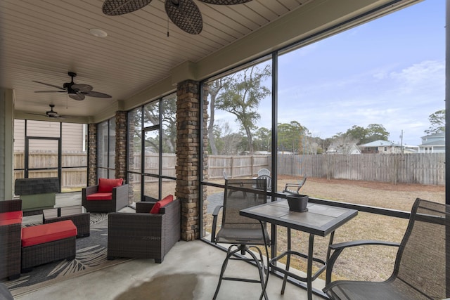 sunroom featuring ceiling fan