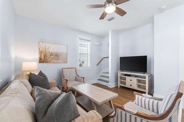 living room featuring hardwood / wood-style floors and ceiling fan