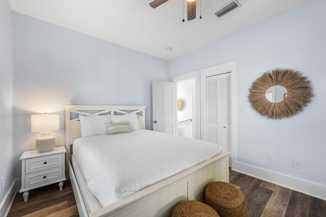 bedroom with ceiling fan, dark hardwood / wood-style floors, and a closet