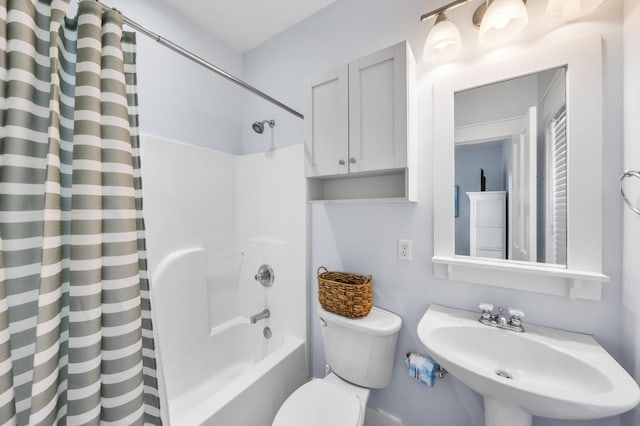 full bathroom featuring sink, shower / tub combo, and toilet