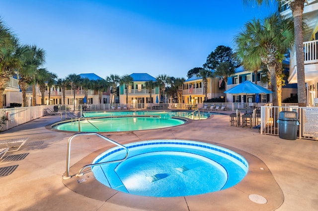 view of pool featuring a community hot tub and a patio