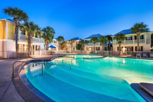 view of pool at dusk