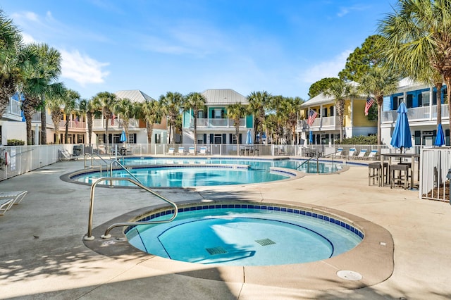 view of pool featuring a hot tub and a patio area