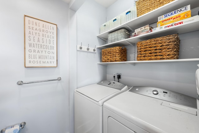 washroom with washing machine and clothes dryer