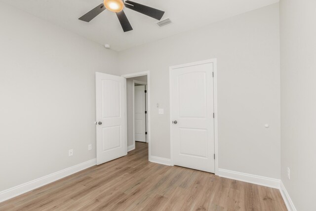 5848 Phillip Rd, Crestview, FL 32539 - unfurnished bedroom with light wood-type flooring, baseboards, and ceiling fan
