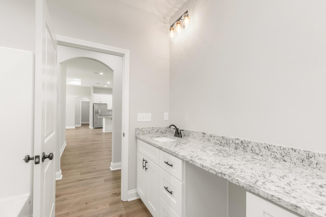 5848 Phillip Rd, Crestview, FL 32539 - bathroom featuring a sink, wood finished floors, and baseboards