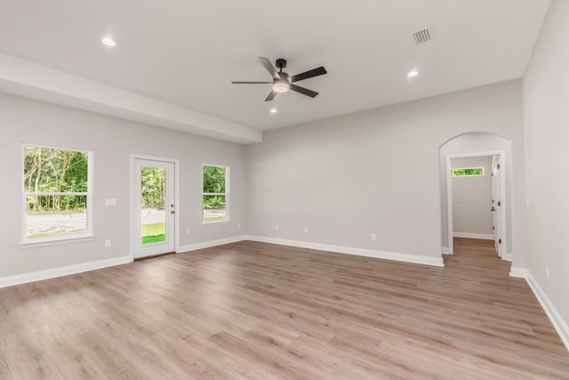 5848 Phillip Rd, Crestview, FL 32539 - empty room with a ceiling fan, healthy amount of natural light, arched walkways, light wood-style floors, and recessed lighting