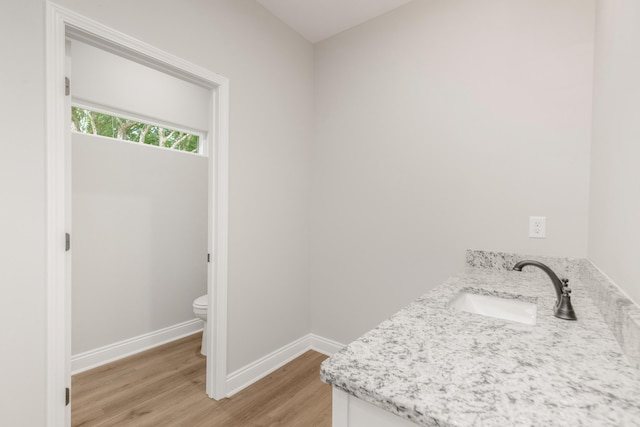 5848 Phillip Rd, Crestview, FL 32539 - bathroom featuring wood finished floors, baseboards, toilet, and vanity