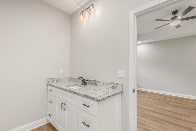 5848 Phillip Rd, Crestview, FL 32539 - bathroom featuring wood finished floors, baseboards, vanity, and ceiling fan