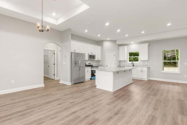 5848 Phillip Rd, Crestview, FL 32539 - kitchen with stainless steel appliances, a center island, light wood-type flooring, white cabinetry, and open floor plan