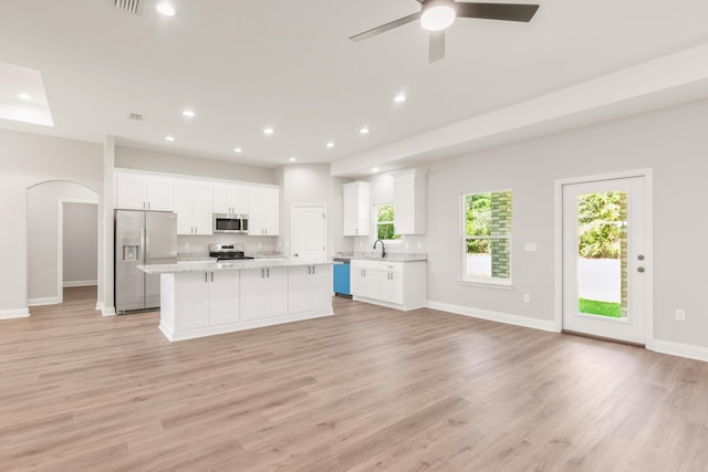5848 Phillip Rd, Crestview, FL 32539 - kitchen featuring stainless steel appliances, white cabinetry, a kitchen island, light wood finished floors, and recessed lighting