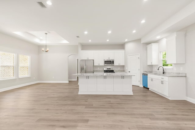 5848 Phillip Rd, Crestview, FL 32539 - kitchen with appliances with stainless steel finishes, baseboards, white cabinets, recessed lighting, and a center island