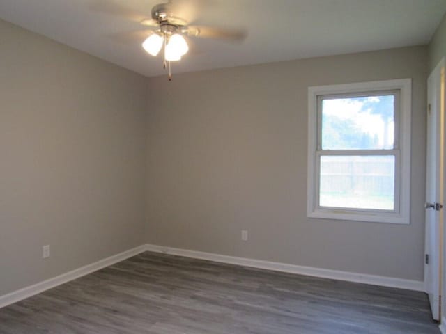 empty room with ceiling fan and dark wood-type flooring