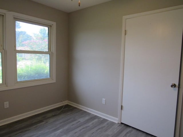 spare room with dark hardwood / wood-style floors