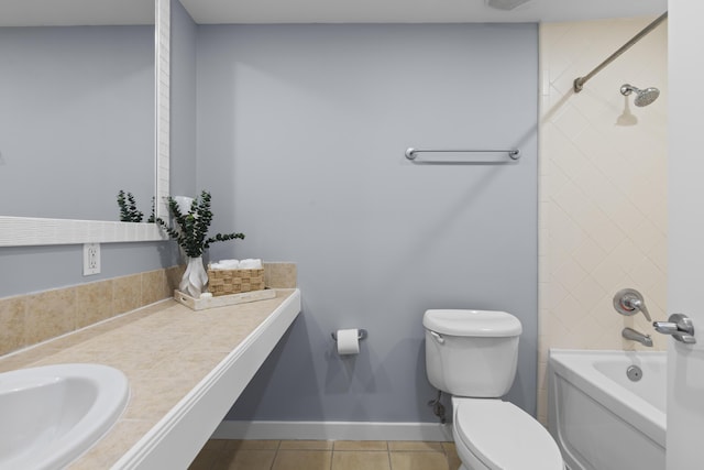 full bathroom with toilet, tiled shower / bath combo, tile patterned flooring, and vanity