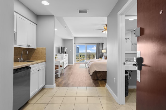 tiled bedroom featuring ceiling fan, sink, and access to outside