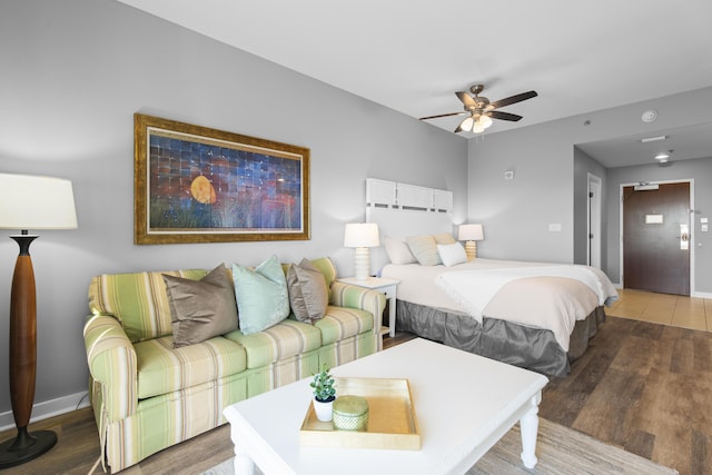 bedroom with ceiling fan and wood-type flooring