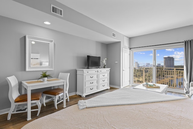 bedroom featuring access to exterior and dark hardwood / wood-style flooring