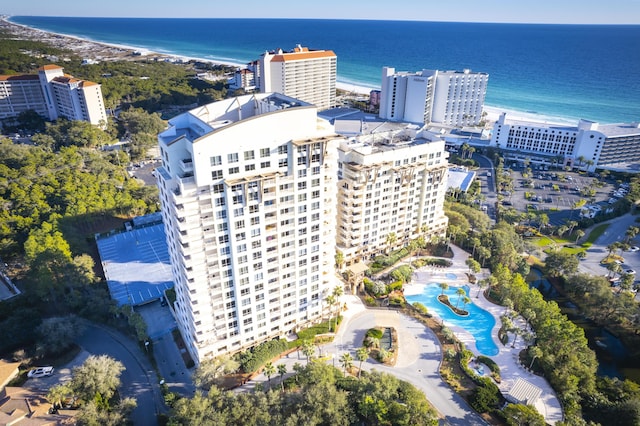 birds eye view of property featuring a water view and a beach view