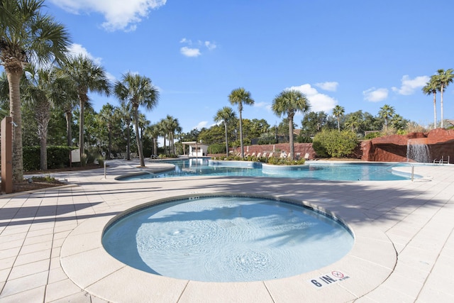 view of swimming pool with a patio area and a hot tub