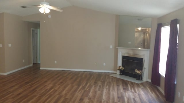 unfurnished living room featuring ceiling fan, vaulted ceiling, and dark hardwood / wood-style floors