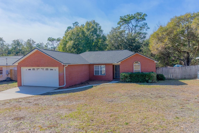 ranch-style house featuring a garage and a front lawn