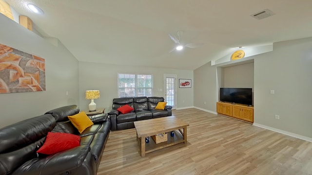 living room with light hardwood / wood-style floors and lofted ceiling