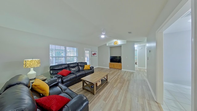 living room with vaulted ceiling and light wood-type flooring