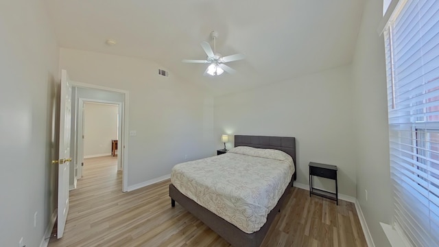 bedroom with ceiling fan, light hardwood / wood-style floors, and lofted ceiling