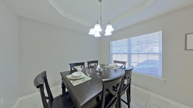 tiled dining area featuring a chandelier