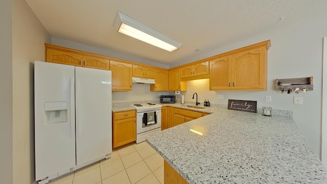 kitchen with white appliances, sink, kitchen peninsula, light tile patterned flooring, and light stone counters