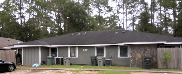 rear view of house featuring central air condition unit