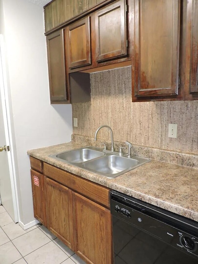 kitchen with light tile patterned floors, dishwasher, and sink