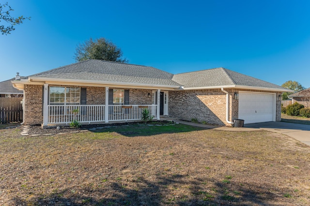 ranch-style home featuring a front yard, a garage, and a porch