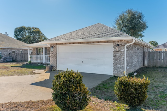 ranch-style house with a front yard, a garage, and a porch