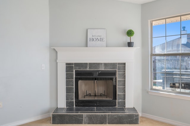 room details with carpet flooring and a tiled fireplace