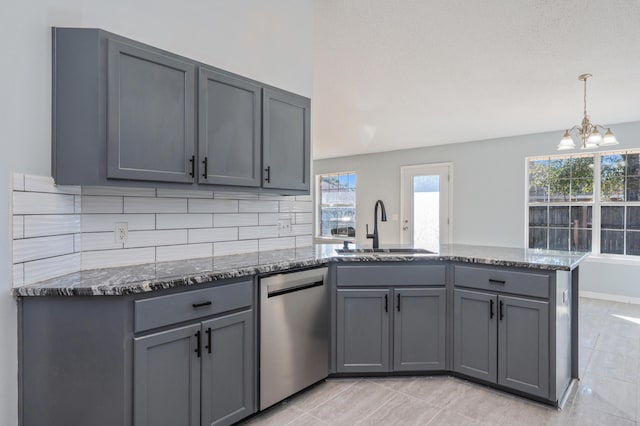 kitchen featuring sink, stainless steel dishwasher, gray cabinetry, and a notable chandelier