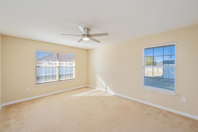 unfurnished room with ceiling fan and light colored carpet