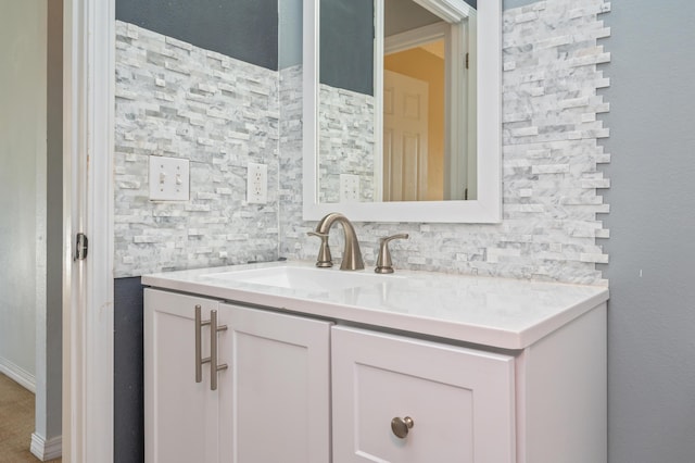 bathroom with tasteful backsplash and vanity