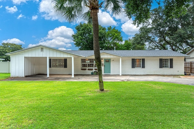 back of property featuring a yard and a carport