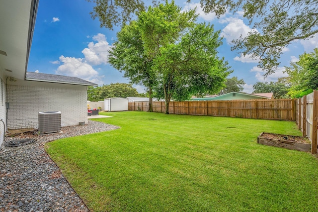 view of yard with central AC unit and a storage unit