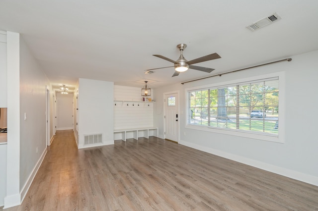 unfurnished living room featuring ceiling fan and light wood-type flooring