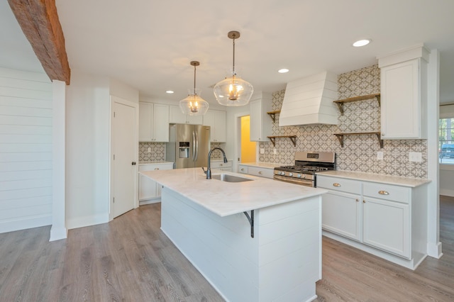 kitchen with pendant lighting, sink, white cabinetry, stainless steel appliances, and custom exhaust hood